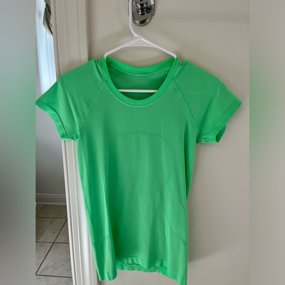Neon green lululemon swiftly t shirt, size 6, hip length, gently worn.